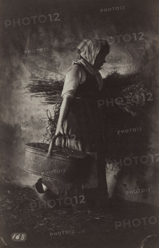 Female Peasant Carrying a Basket and Hay, c. 1870. Auguste Giraudon (French). Albumen print from wet collodion negative; image: 17.2 x 11.1 cm (6 3/4 x 4 3/8 in.); mounted: 20.7 x 15.8 cm (8 1/8 x 6 1/4 in.); matted: 45.7 x 35.6 cm (18 x 14 in.)