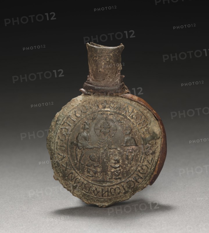 Pilgrim's Ampulla with Scenes of the Crucifixion (front) and the Ascension (back), c. 600. Byzantium, Palestine, early Byzantine period, early 7th Century. Tin-lead alloy with leather fragments; overall: 6.3 x 4.6 x 1.5 cm (2 1/2 x 1 13/16 x 9/16 in.).