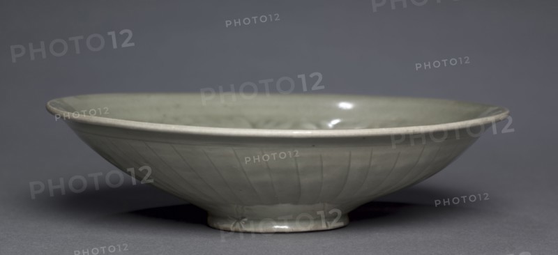 Bowl with Peonies, c. 1100s. China, Shaanxi province, Tongchuan, Huangbaozhen, Jin dynasty (1115-1234). Green-glazed stoneware with molded decoration, Yaozhou ware; overall: 5 x 19.3 cm (1 15/16 x 7 5/8 in.).