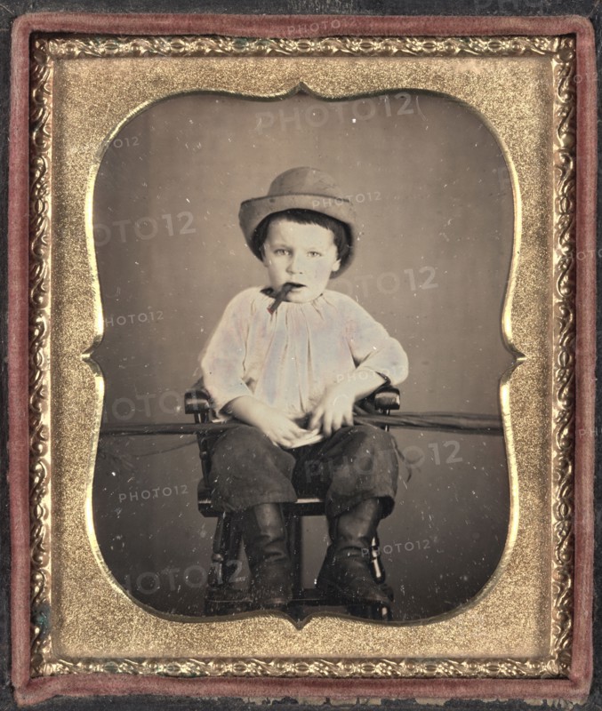 Boy with Cigar, c.1855. Unidentified Photographer. Daguerreotype, tinted, sixth plate; image: 8.3 x 7 cm (3 1/4 x 2 3/4 in.); case: 9.3 x 8 cm (3 11/16 x 3 1/8 in.); matted: 61 x 48.3 cm (24 x 19 in.)