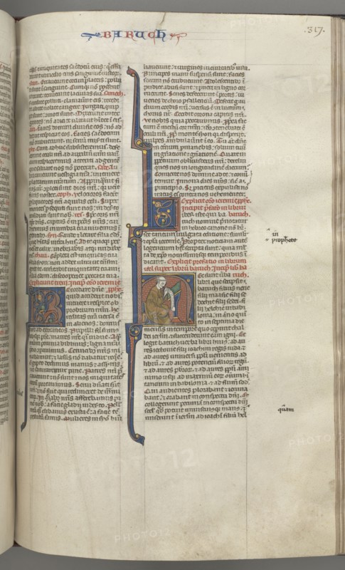 Fol. 317r, Baruch, historiated initial H, Baruch seated at a desk writing on a scroll, c. 1275-1300. Southern France, Toulouse(?), 13th century. Bound illuminated manuscript in Latin; brown morocco binding; ink, tempera and gold on vellum; 533 leaves