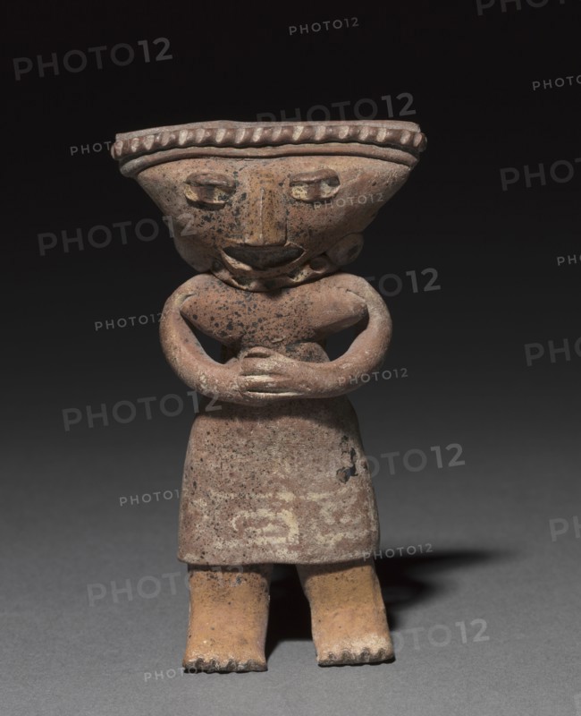 Standing figurine holding an animal (dog?), 300 B.C. to A.D. 300. West Mexico, Colima or Jalisco state, possibly Tuxcacueso-Ortices municipality, 300 B.C. to A.D. 300. Ceramic and pigment; overall: 16 x 8 cm (6 5/16 x 3 1/8 in.).