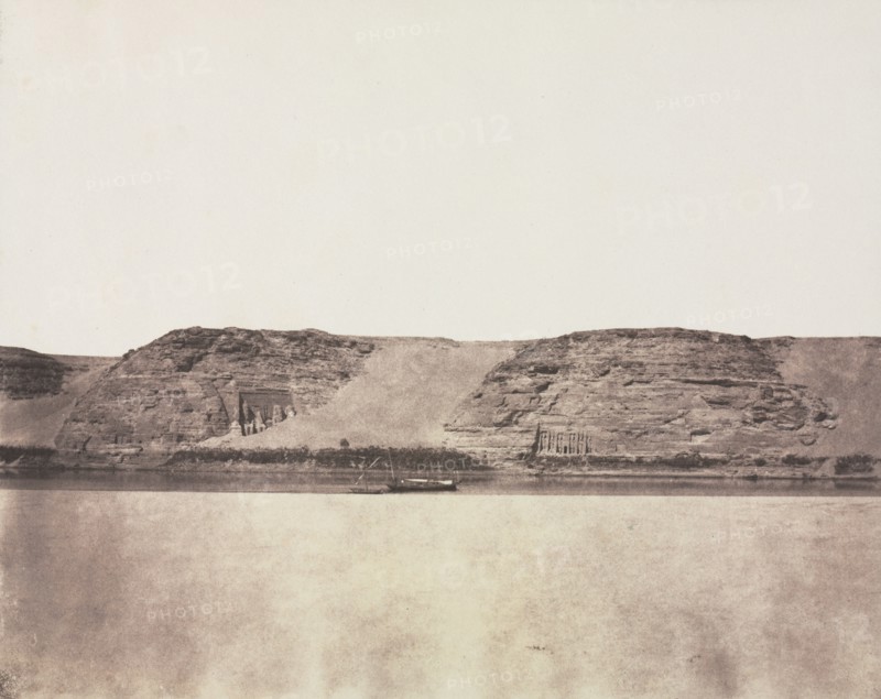 General View of Monuments Carved into Bedrock with Photographer's Dahabieh. Abu Simbel, 1851-1852. Félix Teynard (French, 1817-1892). Salted paper print from a paper negative; image: 24.8 x 30.9 cm (9 3/4 x 12 3/16 in.); paper: 26.7 x 35.5 cm (10 1/2 x 14 in.); matted: 50.8 x 61 cm (20 x 24 in.)