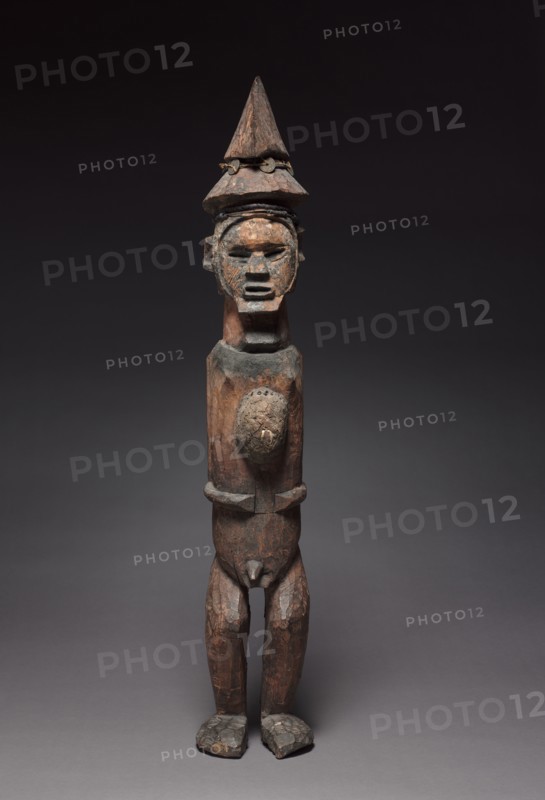 Male Figure, late 1800s-early 1900s. Central Africa, Republic of the Congo (most likely) or Democratic Republic of the Congo, Teke people. Wood, resin, iron, copper, fiber, fabric, cowries, beads, coins, antelope horns; overall: 97.1 cm (38 1/4 in.); without base: 91.5 x 16 x 16.3 cm (36 x 6 5/16 x 6 7/16 in.)