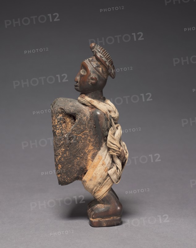 Male Figurine, late 1800s-early 1900s. Central Africa, Democratic Republic of the Congo (most likely), Cabinda, or Republic of the Congo, probably Yombe people. Wood with fabric; overall: 17 x 5.3 x 7 cm (6 11/16 x 2 1/16 x 2 3/4 in.)