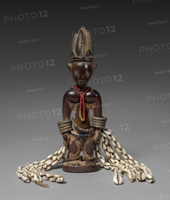 Memorial Figure (Ere ibeji), late 1800s-early 1900s. Guinea Coast, Nigeria, Yoruba people. Wood, metal, beads, cowries, fiber, blue pigment; overall: 25.6 x 18.8 x 5.8 cm (10 1/16 x 7 3/8 x 2 5/16 in.)