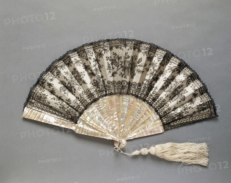 Folding Fan: Chantilly Lace, c. 1870. France (probably), 19th century. Black "Chantilly" lace over silk lining, white silk tassel; frame: mother-of-pearl; radius: 27 cm (10 5/8 in.); spread: 49.5 cm (19 1/2 in.).