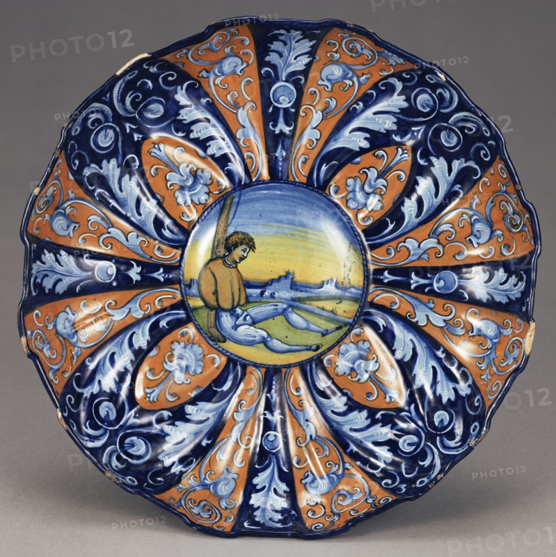Molded Dish with an Allegory of Love; Faenza, Emilia-Romagna, Italy; about 1535; Tin-glazed earthenware; 7.3 x 27.9 cm