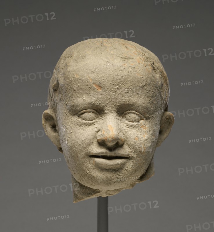 Head of a Child; Tarentum, Taras, South Italy; 300 - 200 B.C; Terracotta with clay slip; 13.5 × 11.5 cm, 5 5,16 × 4 1,2 in