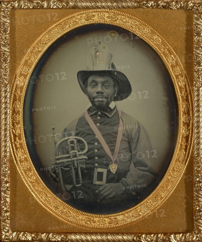 Fireman in Uniform Holding a Brass Instrument; American; 1855 - 1856; Daguerreotype, hand-colored; 6 x 4.9 cm