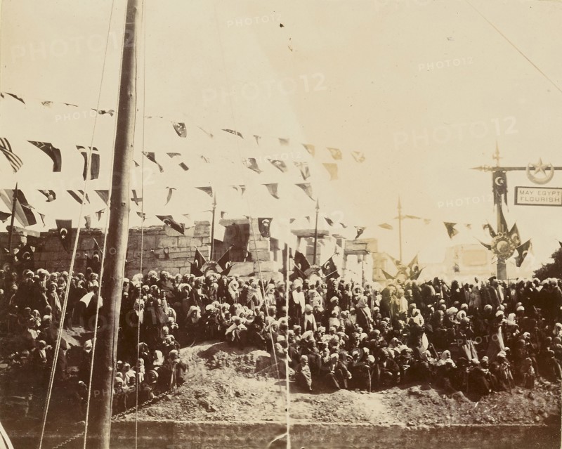 Crowd under multi-national flags; Egypt; about 1860 - 1880; Tinted Albumen silver print
