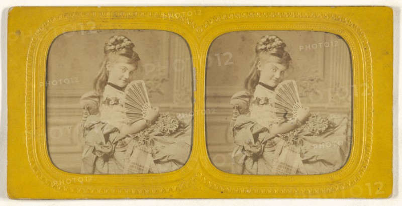 Woman seated on a divan holding a hand fan; E. Lamy, French, active 1860s - 1870s, 1860s; Hand-colored Albumen silver print