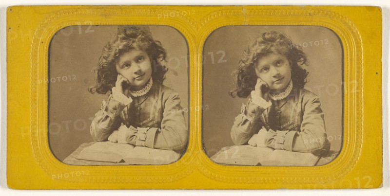 Little girl seated with hand on cheek, open book in front of her; 1855 - 1860; Hand-colored Albumen silver print