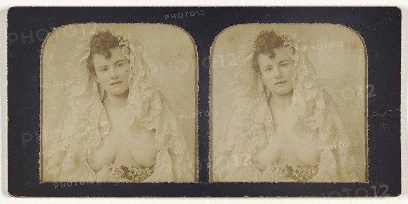 Woman wearing a lace mantilla with breasts exposed; French; 1855 - 1860; Hand-colored Albumen silver print