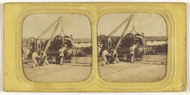 Men loading large iron wheels on platform; about 1865; Hand-colored Albumen silver print
