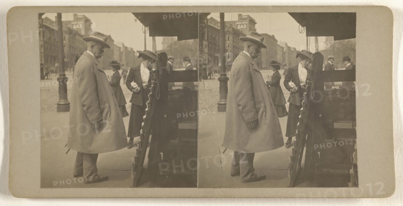 Elder man with hat reading newspapers at rack, Albany, N.Y; Julius M. Wendt, American, active 1900s - 1910s, 1900s; Gelatin