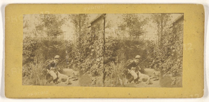 Boy in riding outfit playing in garden; about 1860; Albumen silver print