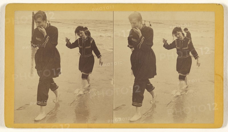Man and woman dressed in similar costumes walking across beach; about 1865; Albumen silver print