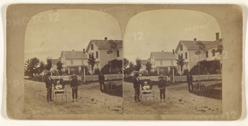 Children posed on street, baby girl in carriage; about 1865; Albumen silver print