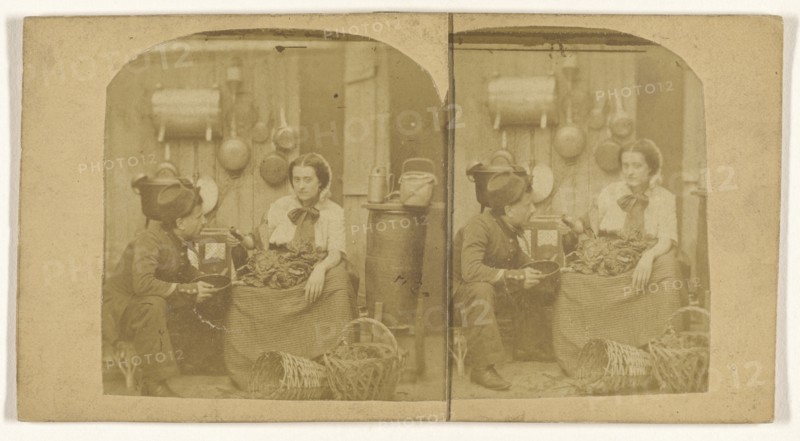 Woman seated in kitchen with foodstuffs on her lap, pouring wine into a pot being held by a man wearing a hat; French