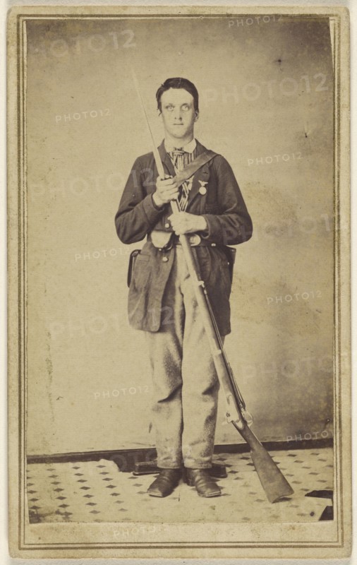 man holding a musket with bayonet attached, standing; 1860s; Albumen silver print