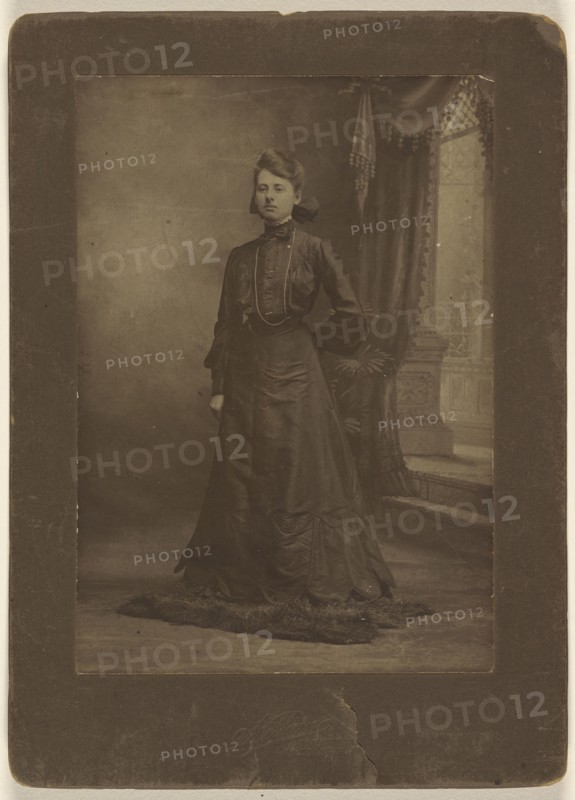 Portrait of a young woman in long black dress, standing; George W. Killian, American, 1876 - 1938, about 1900; Gelatin silver