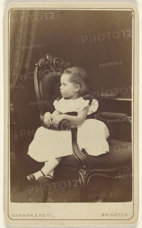 Little girl seated sideways in an armchair; Hennah & Kent; about 1870; Albumen silver print