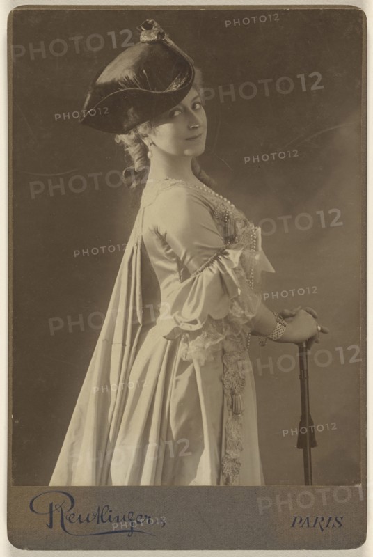 woman wearing a dark hat, standing, with hands resting on a walking stick; Emile Auguste Reutlinger, French, 1825 - 1907