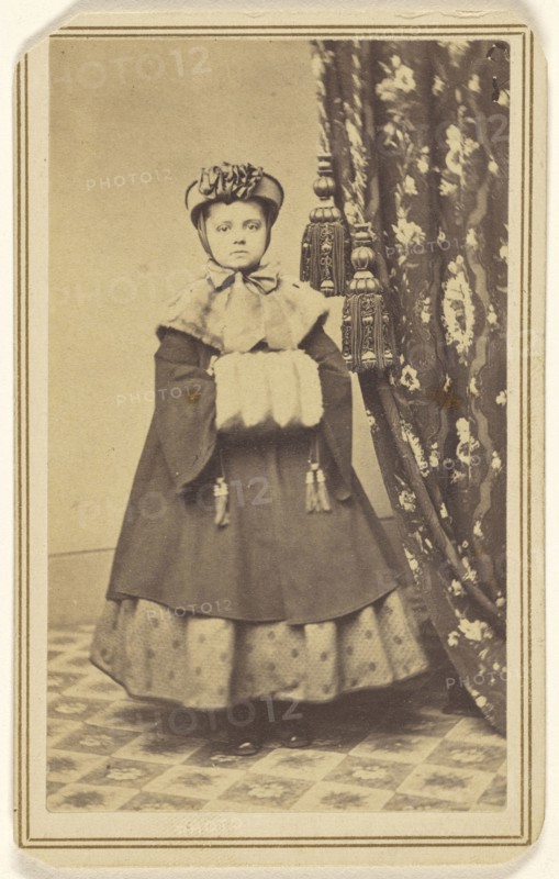 little girl dressed in winter clothing with hand muff, standing; Emery R. Gard, American, active 1856 - 1866, 1865 - 1870
