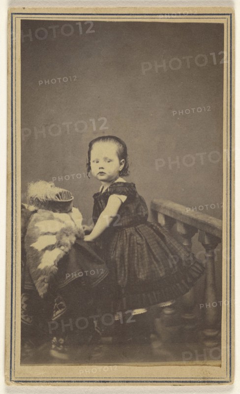 little girl standing, leaning on a prop in a studio; S. Bruckner; 1865 - 1870; Albumen silver print