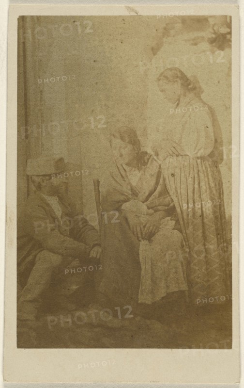 Woman seated holding a baby, a man and woman on either side; 1865 - 1870; Albumen silver print