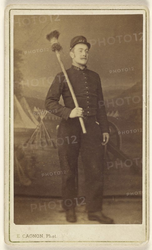 man in uniform standing, with what is possibly a cannon sponge over his shoulder; E. Cagon, French, active Argentina 1860s