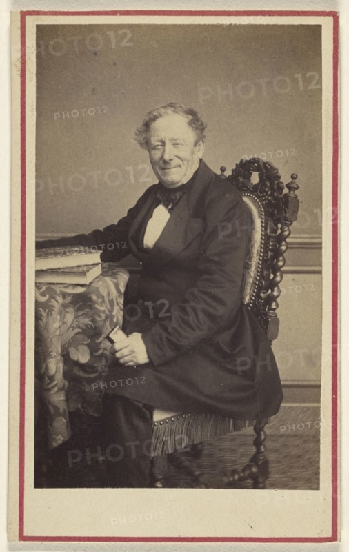 man seated at a table with books on top; Emile Renaut, French, active Chaumont, France 1860s, 1870 - 1875; Albumen silver print