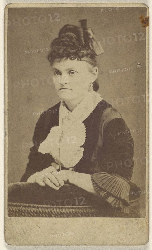 woman seated, leaning on chair arm; T.M. Saurman, American, 1846 - 1908, active Norristown, Pennsylvania, 1870 - 1875; Albumen