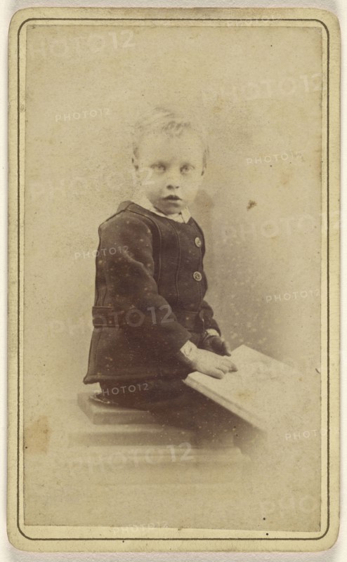 little boy seated with an open book on his lap; John McKean, Scottish, active Leith, Scotland 1880s - 1890s, 1870 - 1880