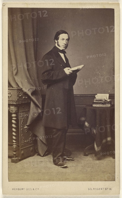 man with long sideburns standing with an open book; Herbert Ogg & Company; about 1865; Albumen silver print