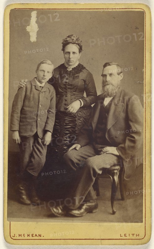 Portrait of an  family: mother and son standing, bearded father seated; John McKean, Scottish, active Leith, Scotland 1880s