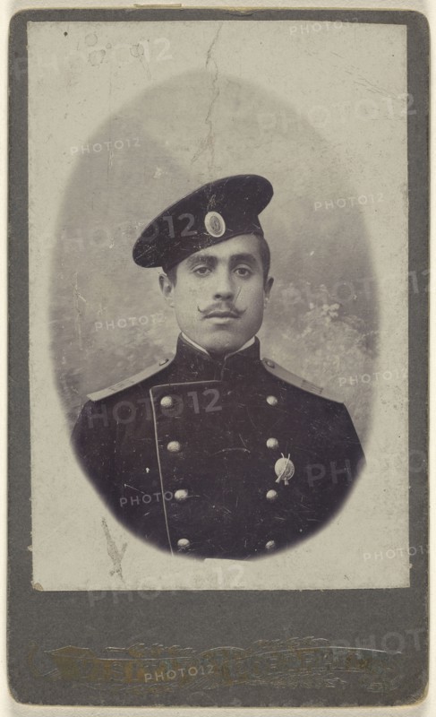 military man with moustache wearing a cap, a pin on his lapel; 1880 - 1885; Albumen silver print