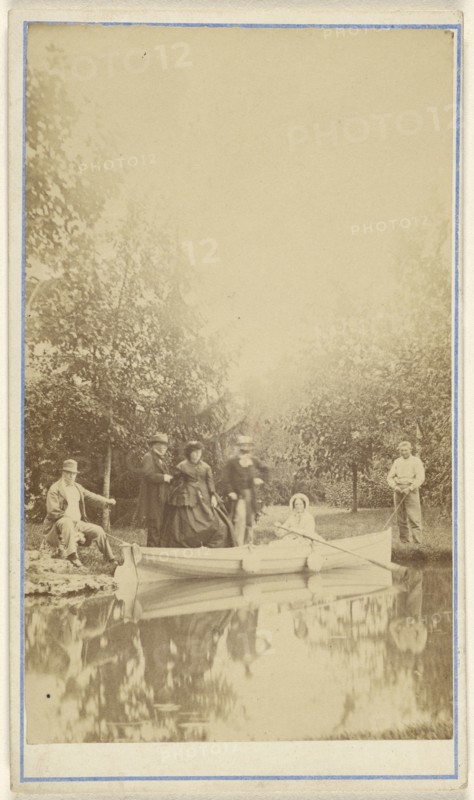Group of people near a lake, one woman in a canoe; 1870 - 1880; Albumen silver print