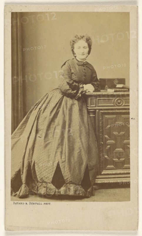 woman standing, leaning against a credenza; Bayard & Bertall; about 1861; Albumen silver print