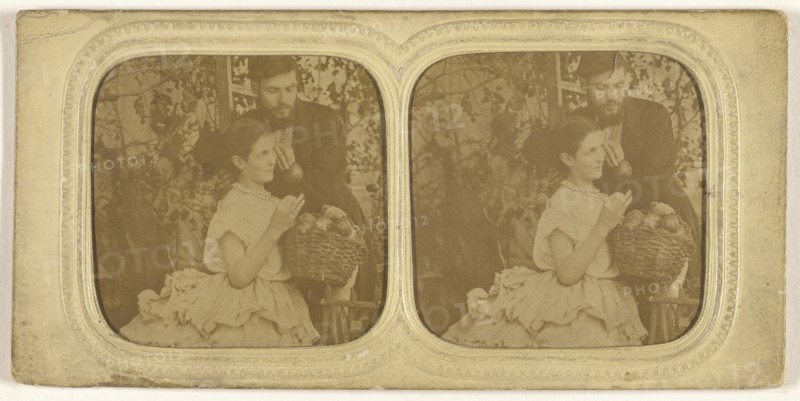 couple: bearded man holding a single piece of fruit with a woman holding a basket of fruit; about 1865; Hand-colored Albumen