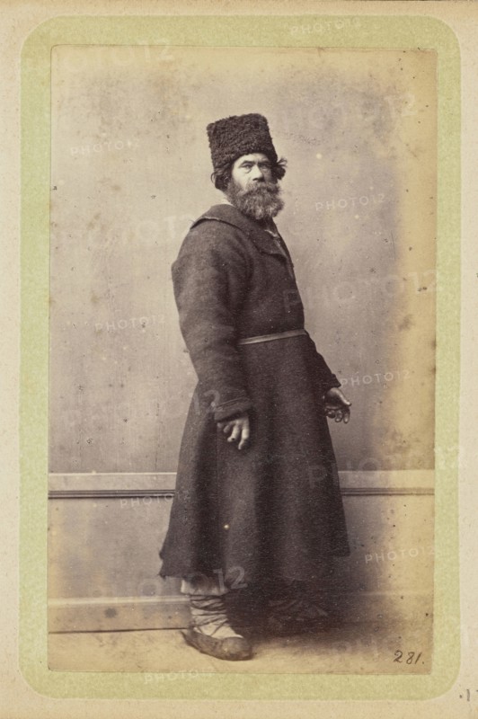 Bearded man posing in long, dark coat and wool hat; William Carrick, Scottish, 1827 - 1878, Russia; about 1860 - 1870; Albumen
