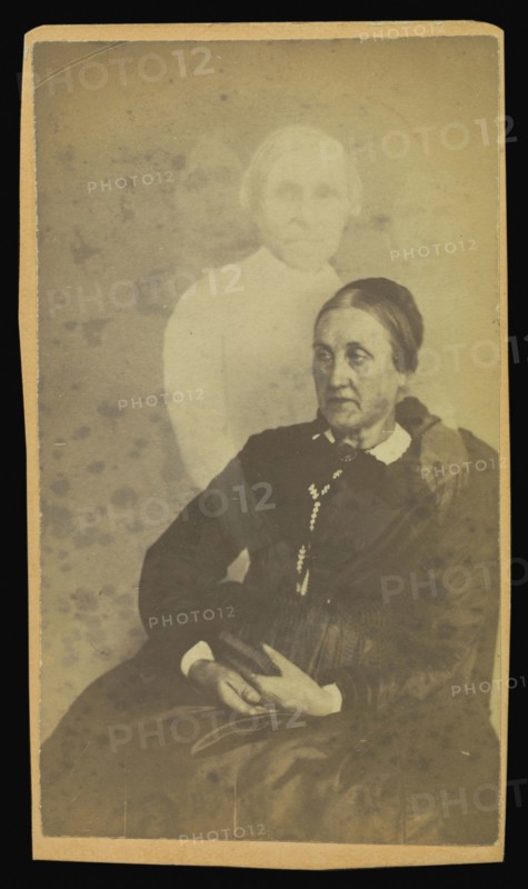 elderly woman seated, three  spirits  in the background; William H. Mumler, American, 1832 - 1884, Boston, Massachusetts