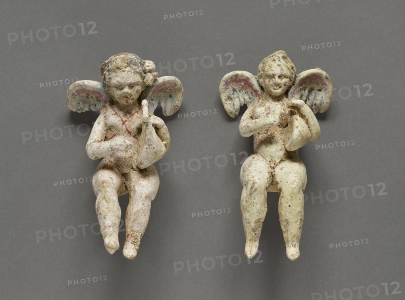 Seated Eros; Canosa, South Italy; 325 - 200 B.C; Terracotta with white slip and polychromy, pink, black, light blue, white, red
