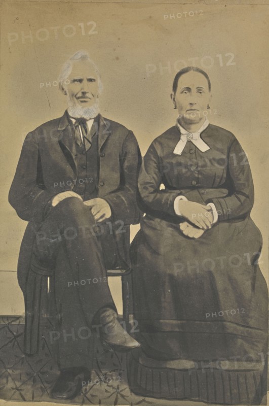Portrait of a seated couple; American; about 1850 - 1860; Hand-colored salted paper print; 21.3 × 14.6 cm, 8 3,8 × 5 3,4 in