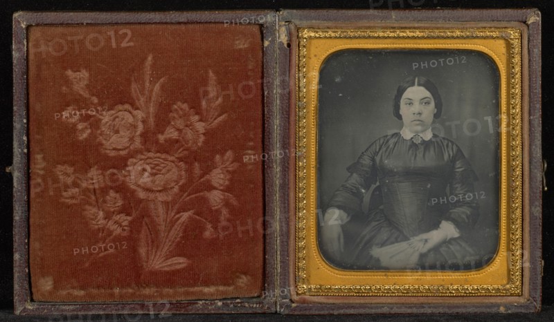 Portrait of a Woman in a Black Dress Seated and Holding a Fan; Mexico; 1856; Hand-colored Daguerreotype