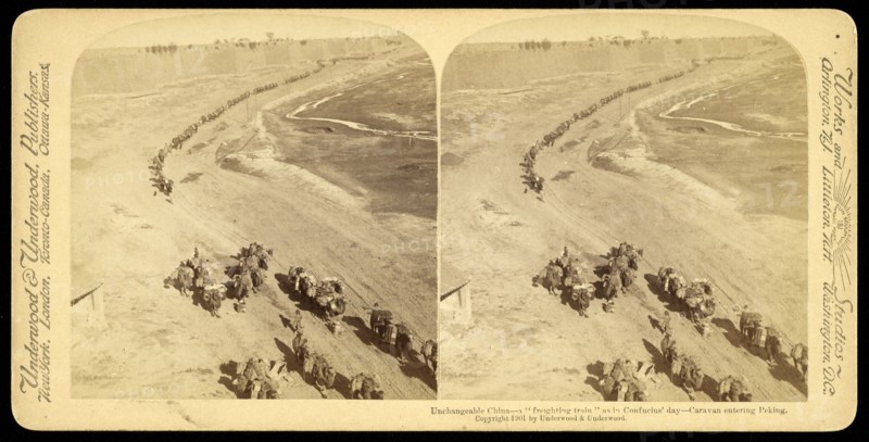 Unchangeable China, a 'freighting train' as in Confucius' day, caravan entering Peking, Underwood and Underwood, Gelatin silver