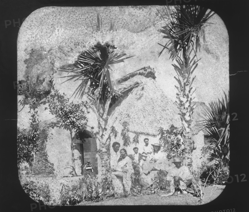 Alice Le Plongeon and a Yucatecan family in front of a thatched house, Augustus and Alice Dixon Le Plongeon papers, 1763-1937