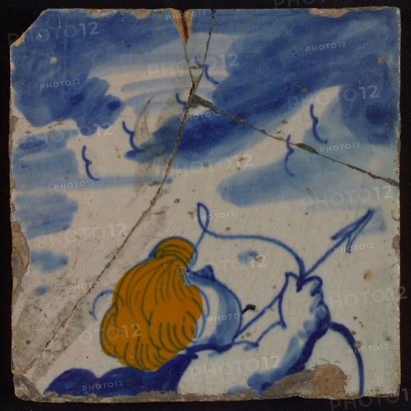 Multicolored tile, blue on white background, coloring brown - yellow, right upper arm and cup of Amor with bow and arrow