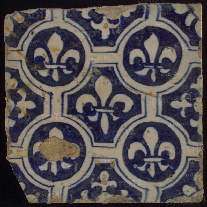 Two-tone tile, blue on white background, four circles with white French lily around central ornament with lily, wall tile